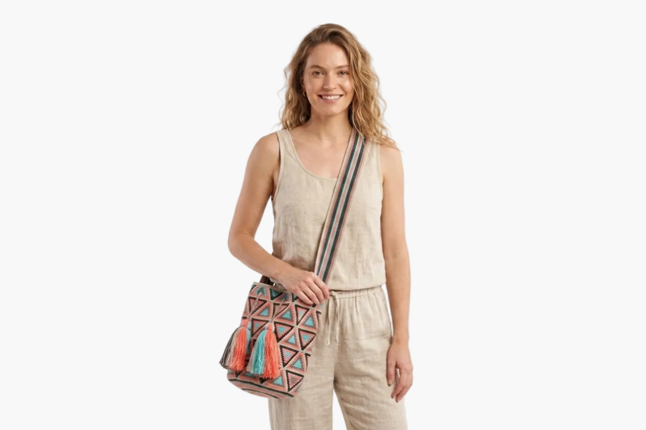 Woman holding a colorful bag with geometric patterns on a white background