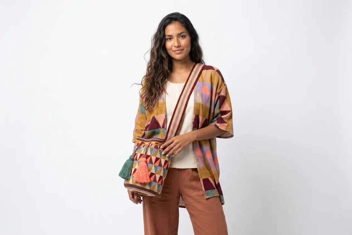 Woman wearing a patterned shawl over a plain background