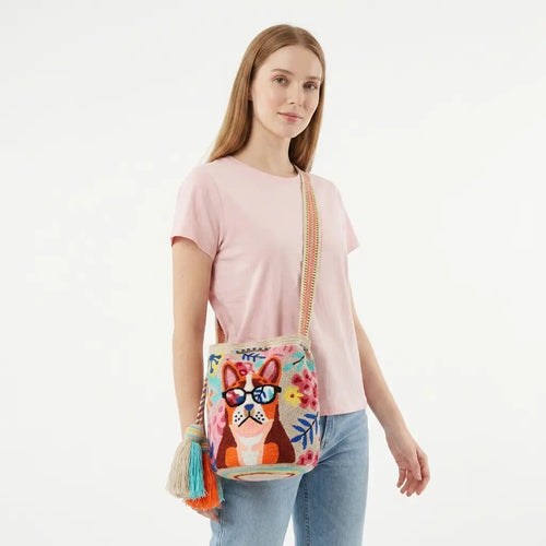 Woman holding a colorful handbag with a dog design on a white background