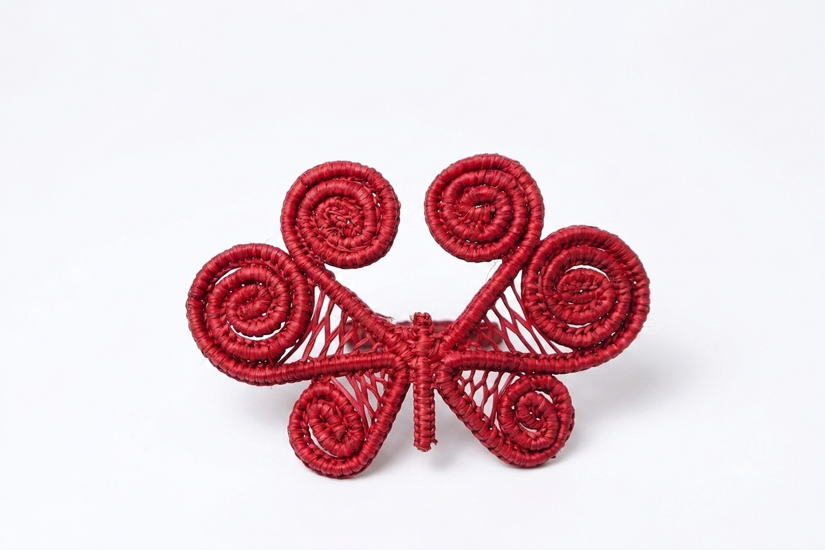 Red butterfly-shaped decorative item on a white background